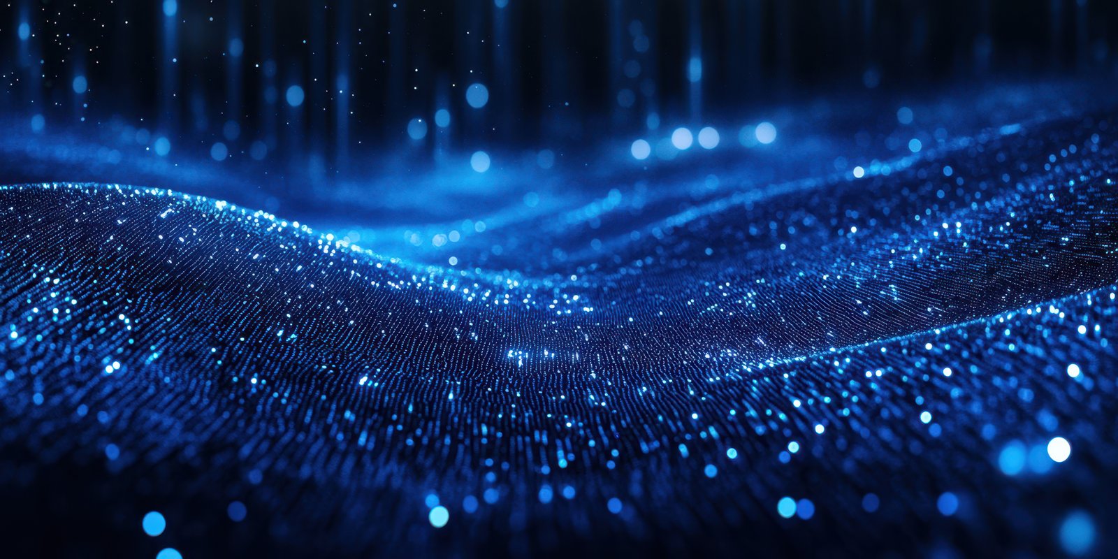 Electric blue waves of light create a mesmerizing effect in a dark space